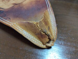 修理前のハンティングチェア座面の破れた脚止め