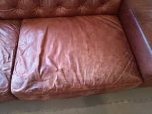 修理前の本革ソファ座面の破れ