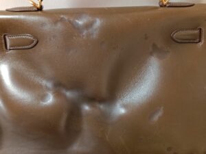 修理前のエルメスケリーバッグ背面の変形
