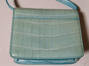 修理前の色褪せたクロコダイルレザーバッグ背面